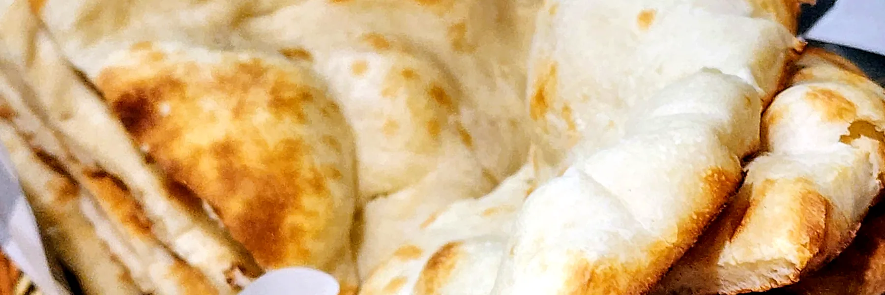 Fresh naan bread in a basket